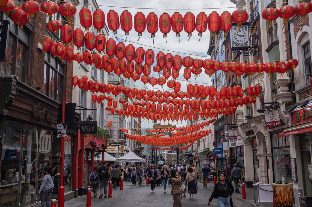 A street in Chinatown London with red lanterns hung across the street