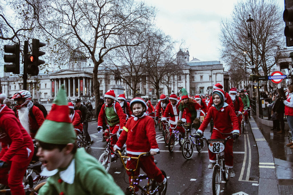 Picture of people dressed as Santa and elves on bikes in front of the National Gallery in London