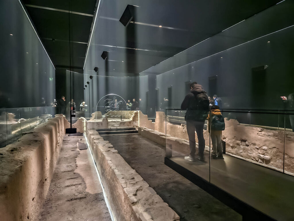The interior of the London Mithraeum immersive experience showing the centre platform